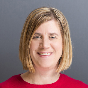 a woman with blonde hair wearing a red shirt